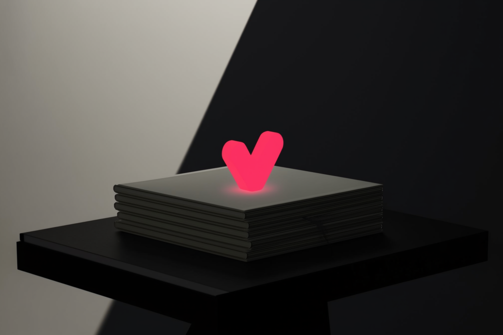 A stack of documents with a glowing coral verification mark above on a dark surface.