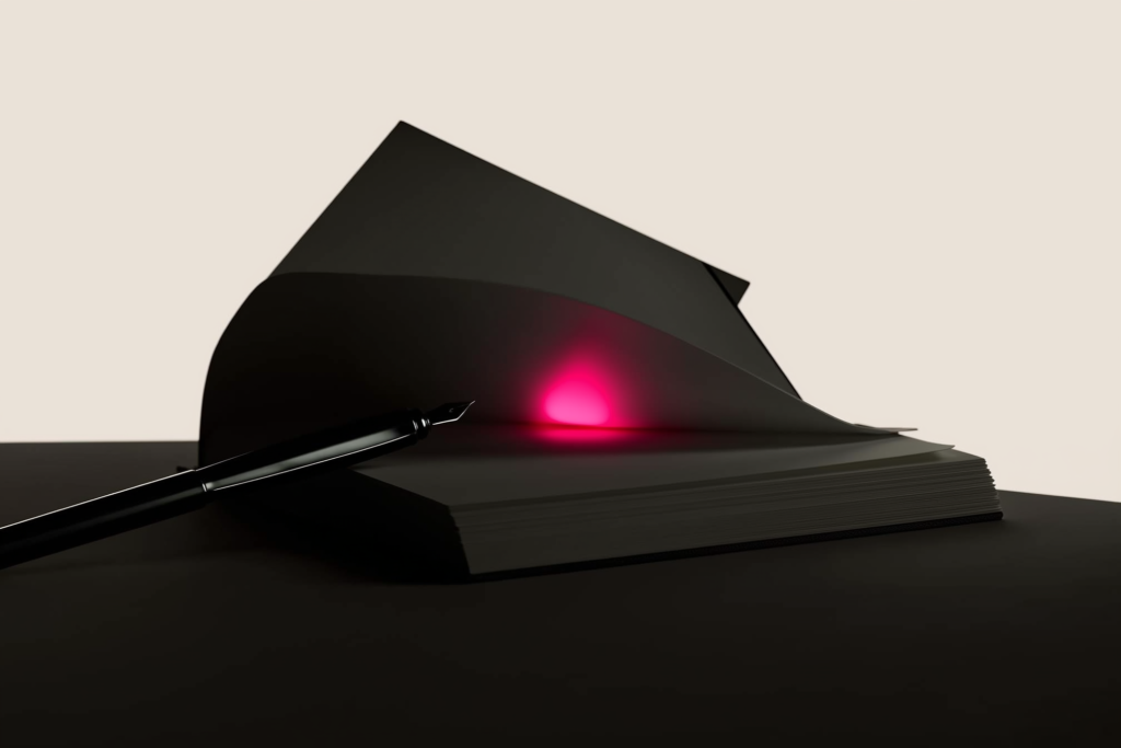 An open notebook on a dark desk with one line glowing coral.