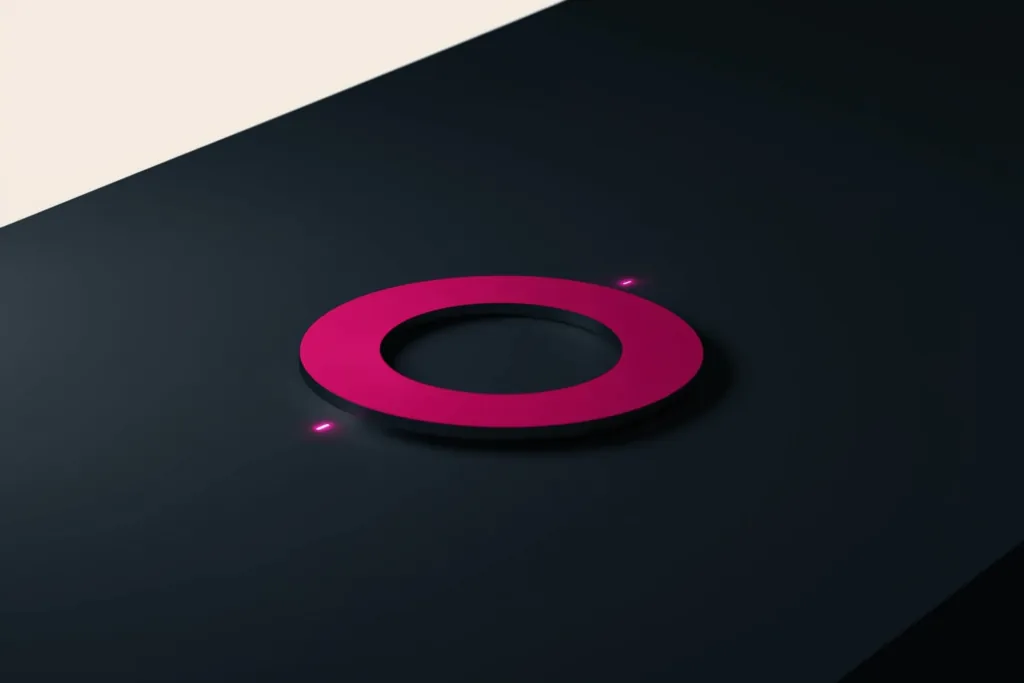 A magnet drawing coral points of light on a dark surface.