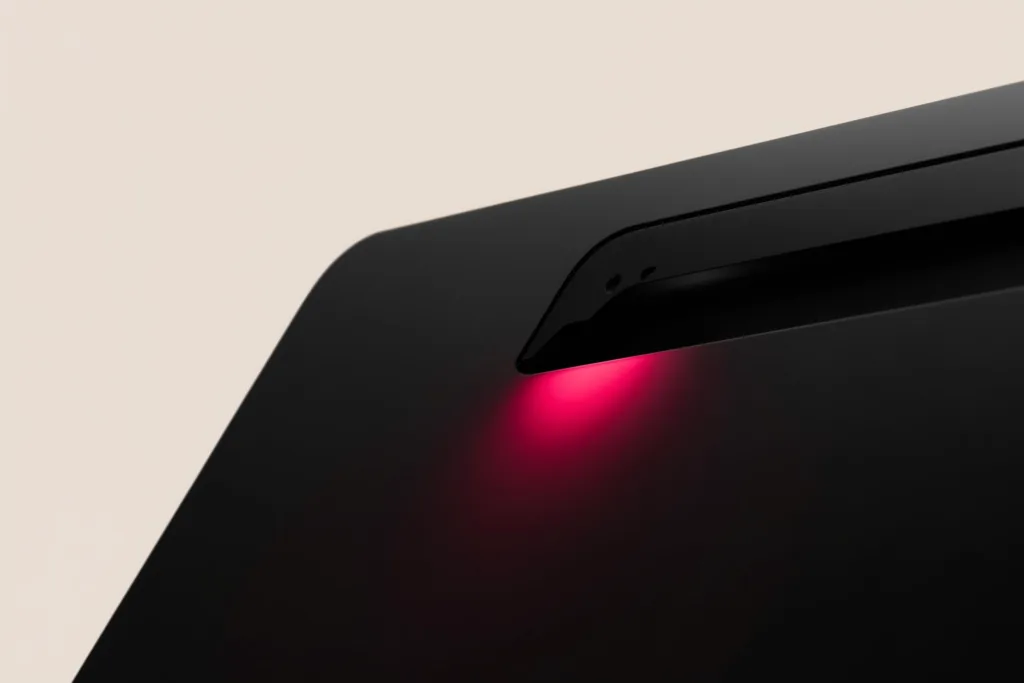 An elegant resort detail on a dark surface with a warm coral accent glow.