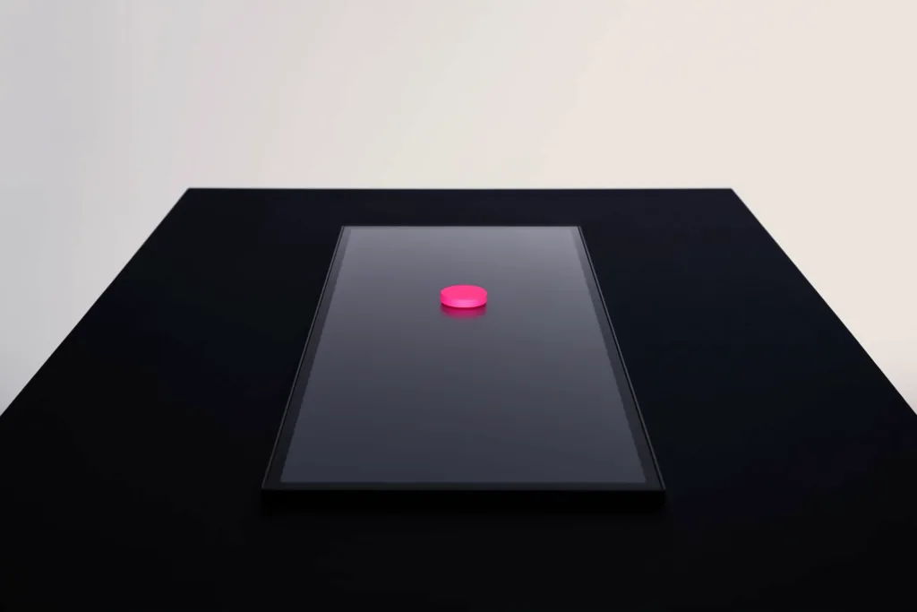 An abstract screen with a glowing coral call-to-action button on a dark surface.