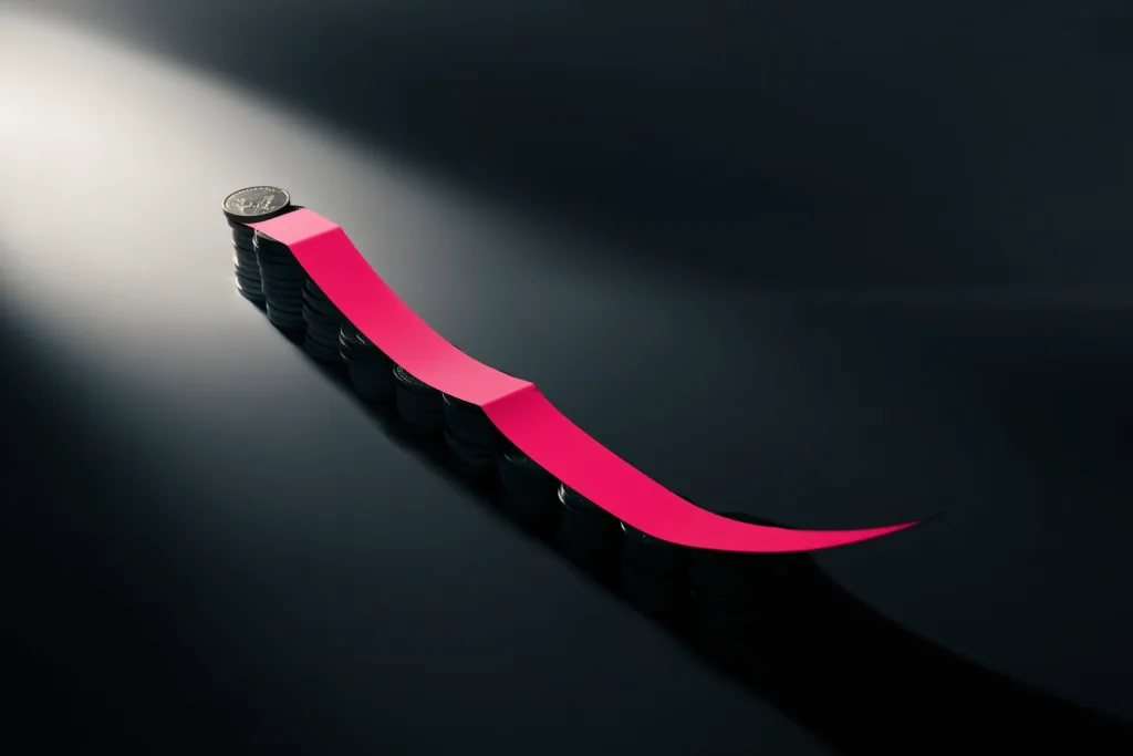 A descending coin stack with a rising coral arrow of light on a dark surface.