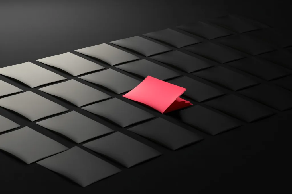 A grid of page cards on a dark surface with one lit in coral.