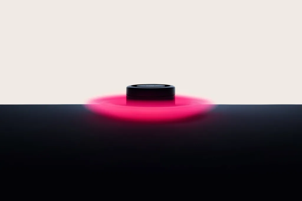 A product inside a coral ring of motion-blur light on a dark surface.