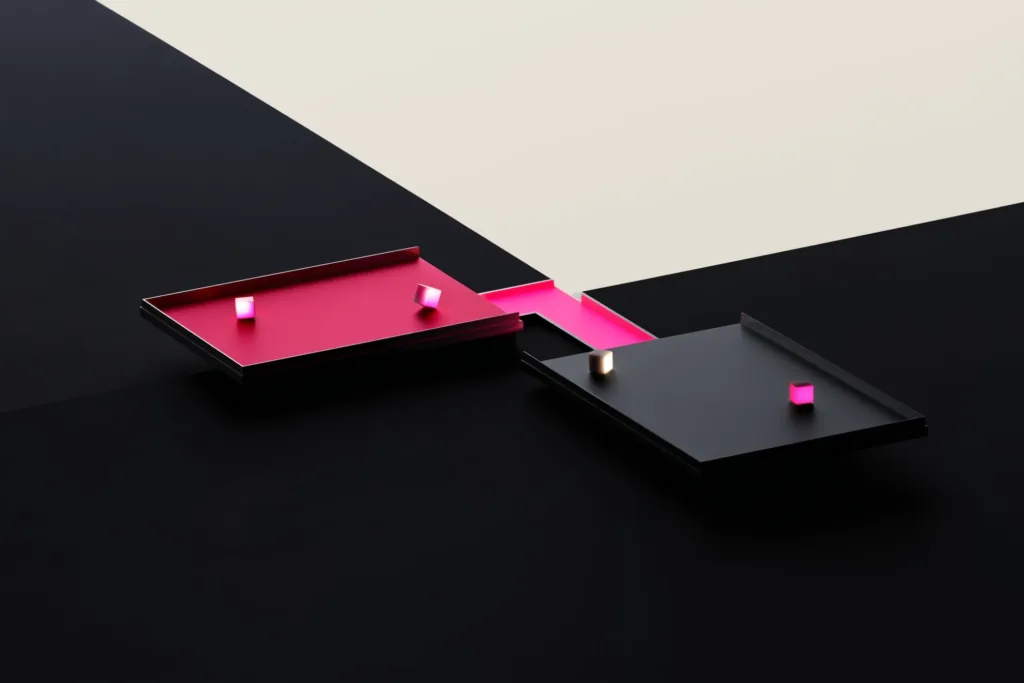Two platforms joined by a coral bridge of light carrying cubes across a dark gap.