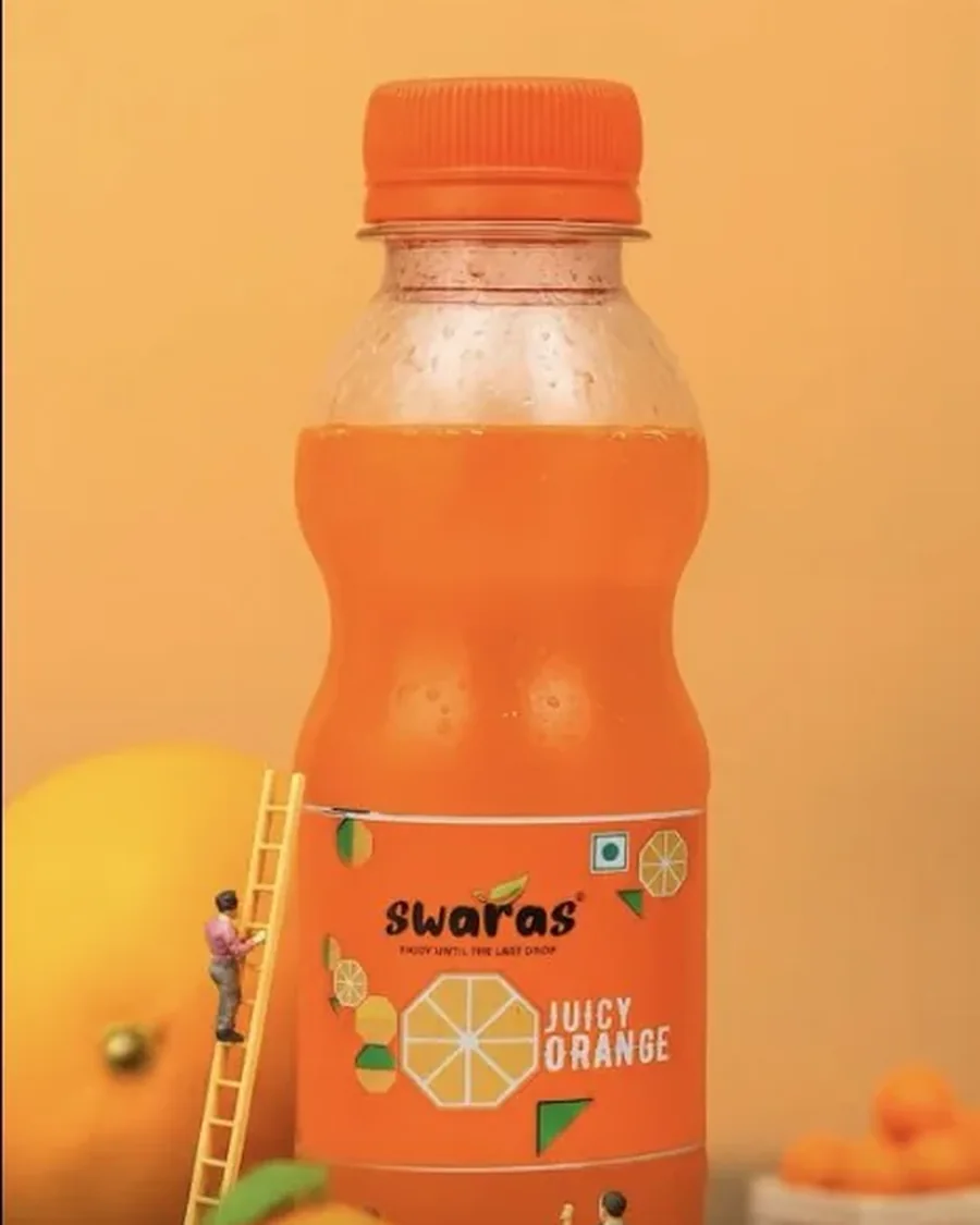 Swaras Juicy Orange bottle in a miniature-set Instagram reel by DESENO